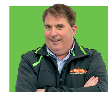 Man in SERVPRO jacket with arms crossed